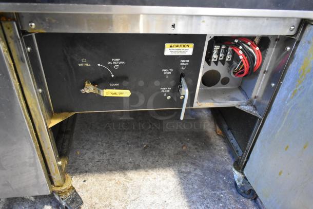 Giles EOF-24 stainless steel 3 bay deep fat fryer with center dumping station, commercial casters, 480V, 3-phase. Visible controls and wiring.
