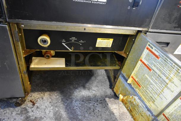 Giles EOF-24 stainless steel electric 3-bay fryer with center dumping station, 480V, 3-phase, on casters, showing control labels.