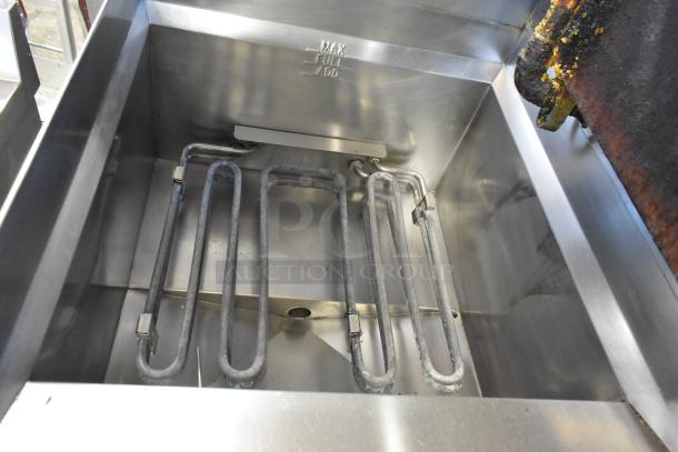 Giles EOF-24 stainless steel 3-bay deep fat fryer with center dumping station, visible heating elements, and "MAX/FULL/ADD" markings.