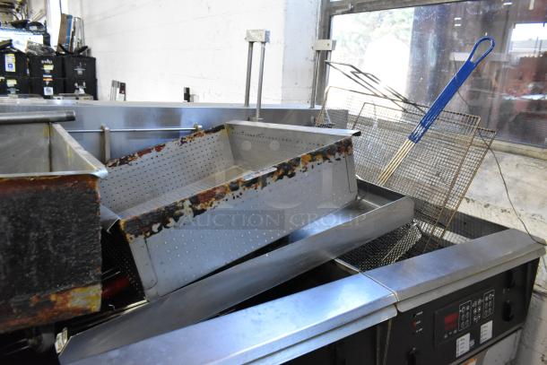 Giles EOF-24 stainless steel electric 3-bay fryer with center dumping station, visible wear, on commercial casters.