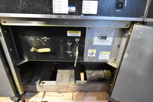 Giles EOF-24 stainless steel commercial fryer, 3-bay, center dumping station, on casters, 480V, 3-phase, visible labels.