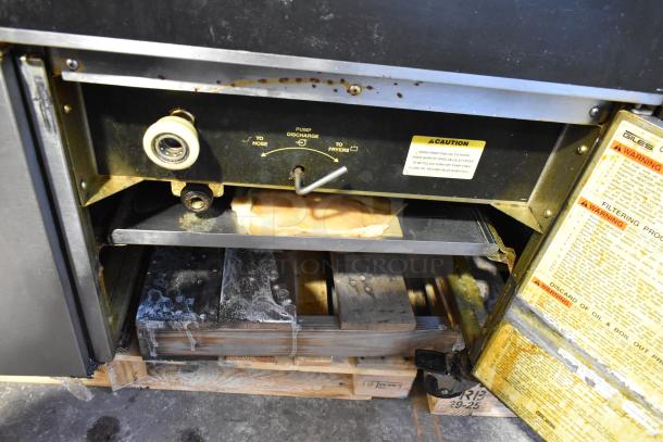 Giles EOF-24 stainless steel 3 bay deep fat fryer on casters, featuring center dumping station, visible caution and warning labels.