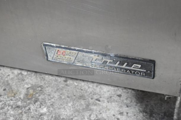 True TWT-72 stainless steel 3-door worktop cooler on casters. Tag shows manufacturing details. 115 volts, 1 phase.