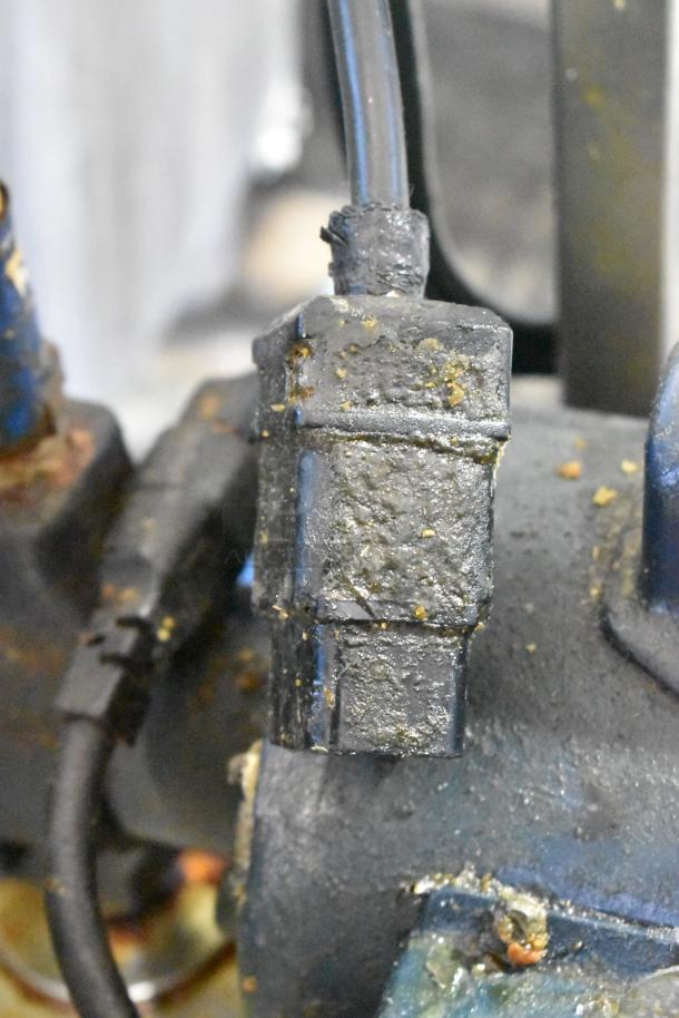 Metal commercial portable oil filter, Model 402. Shows signs of use, 120 volts, 1 phase. Crucial for fryer maintenance.