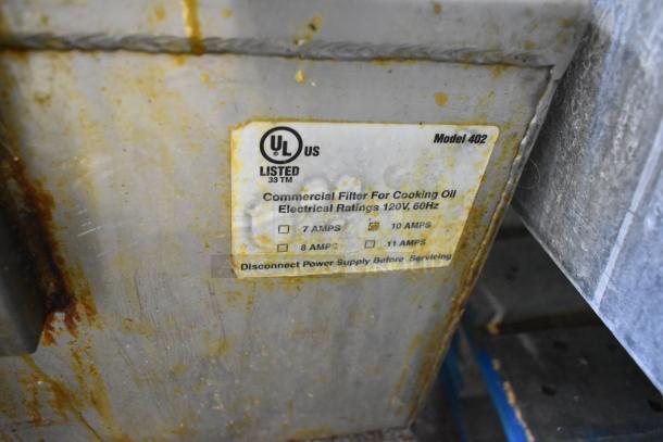 Commercial portable fryer oil filter, model 402, showing UL label. Rated 120V, 60Hz. Visible wear and rust on surface.