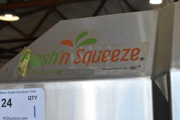JBT POS-1 commercial citrus juicer, stainless steel, on casters, 115V, fresh 'n squeeze label visible.