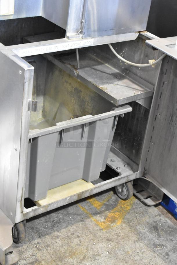 JBT Fresh N Squeeze POS-1 stainless steel citrus juicer on casters, 115V, 1 Phase. Interior view with waste container.
