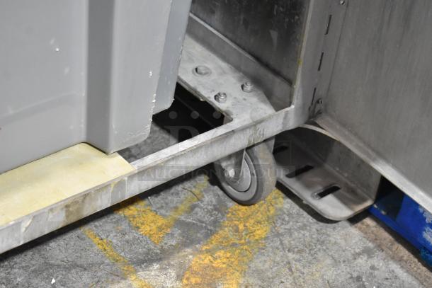 Stainless steel base of JBT Fresh N Squeeze POS-1 citrus juicer with commercial casters, 115V, 1 Phase.