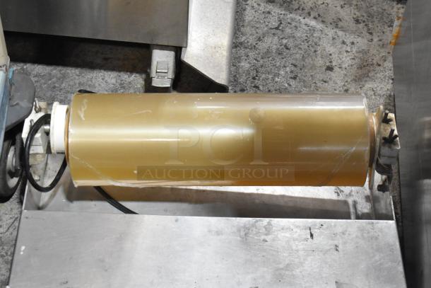 Metal countertop wrapping station, Model 5000156, 115 volts, 1 phase. Used condition, visible electrical wiring.