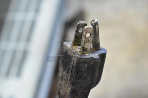 Plug of Model 5000156 Metal Countertop Wrapping Station, showing signs of wear, 115 Volts, 1 Phase.