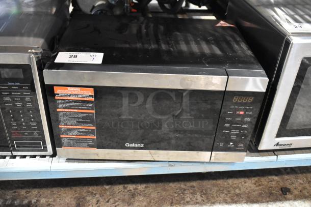 2020 Galanz GSWWD09S1A09A countertop microwave, black and stainless steel, 120V, with control panel and visible label.