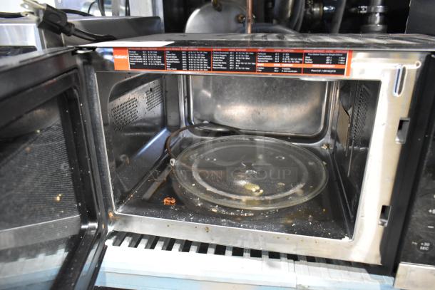 2020 Galanz GSWWD09S1A09A countertop microwave, used condition with visible interior food debris, 120V, includes glass plate.