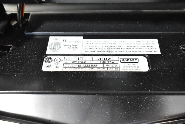 2020 Hobart HTi-7LH4W metal commercial countertop scale, 120/208-240V, 1 phase. Label shows model and compliance details.