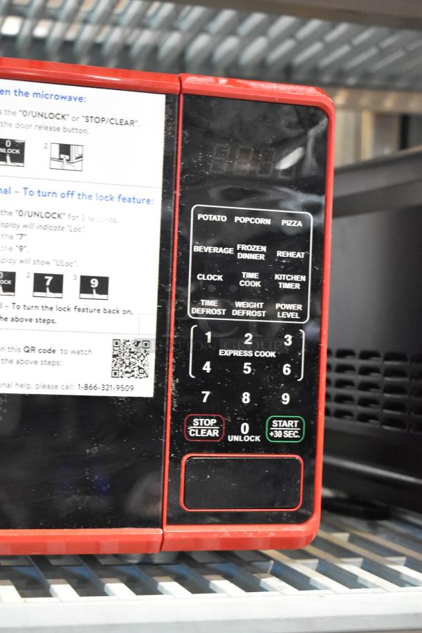 2024 Mainstays MS8436127995-02 metal countertop microwave, red trim, control panel with cooking presets and function labels.