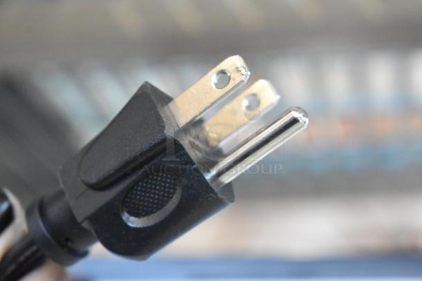 Close-up of a standard plug for a Mainstays MS8436127995-02 microwave oven.