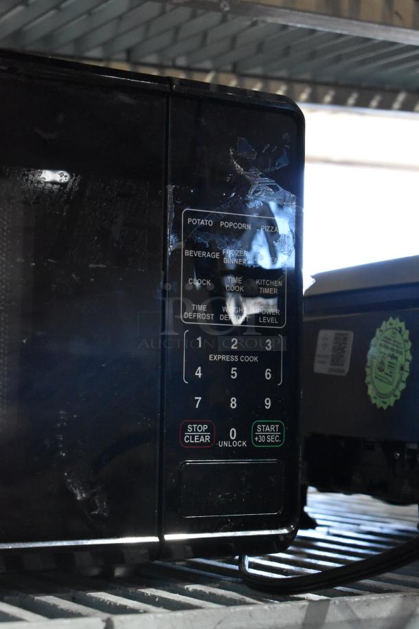 2024 Mainstays MS8436127995-01 metal microwave, 120 volts, keypad presets visible, good condition.