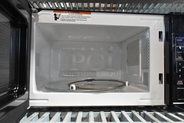 2024 Mainstays MS8436127995-01 metal countertop microwave oven, white interior, with plate, 120V, 1 phase. Warning label visible.