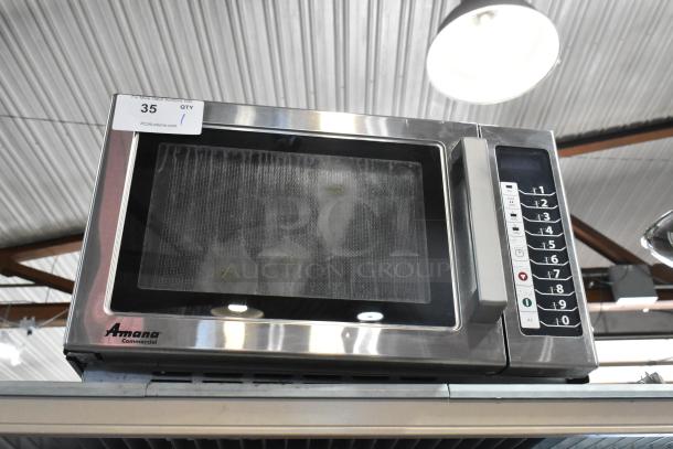 Amana RCS10TS stainless steel commercial countertop microwave oven, visible controls, model label, good condition.
