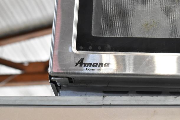 Amana RCS10TS stainless steel commercial microwave oven, visible brand logo, countertop model, condition appears used.