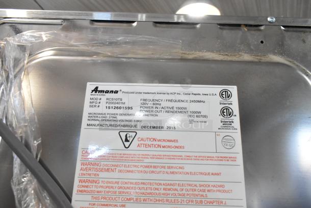 Amana RCS10TS stainless steel commercial microwave oven, 120V, 1 phase, labels showing model, manufacturing details.