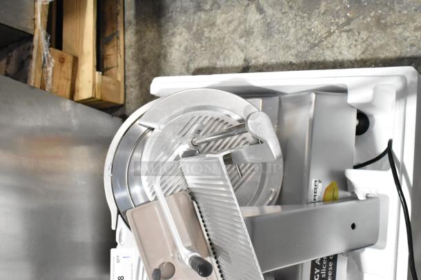 Bizerba metal commercial countertop meat slicer, 120 volts, 1 phase; includes blade and adjustable settings, in good condition.