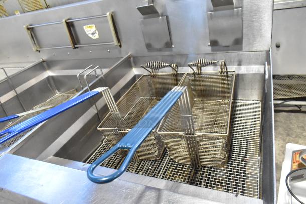 Giles EOF-24 stainless steel 3-bay deep fat fryer with center dumping station, on commercial casters, 480V, 3-phase.