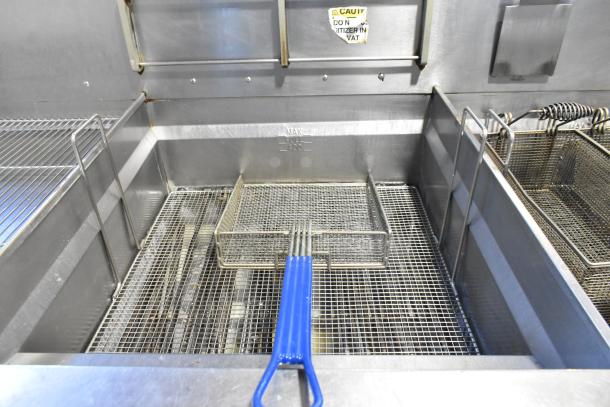 Giles EOF-24 stainless steel electric 3-bay deep fryer with center dumping station, commercial casters, 480V, 3-phase.
