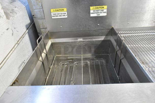 Giles EOF-24 stainless steel electric 3-bay fryer with center dumping station, commercial casters, 480V, 3 phase. Labels indicate caution for water use only.