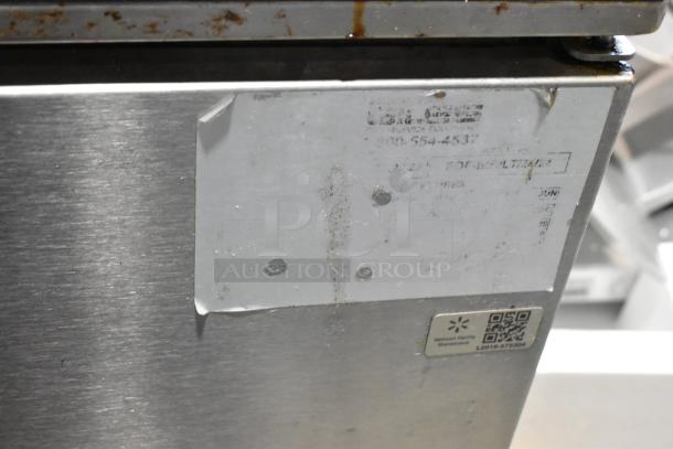 Giles EOF-24 stainless steel 3-bay fryer, center dumping station, and commercial casters. 480V, 3-phase. Visible labels.