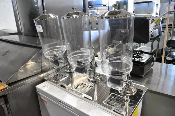 Brand new chrome finish 3-hopper dry goods dispenser, clear poly construction, with minor scratches and dents.