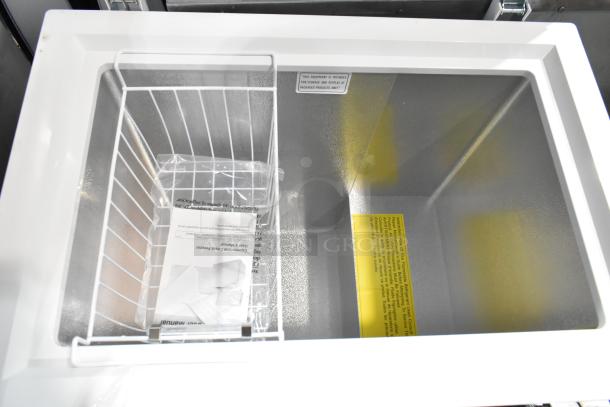 Galaxy 177CF5 metal chest freezer with hinge lid, interior view showing basket, user manual, and warning labels. Good condition.