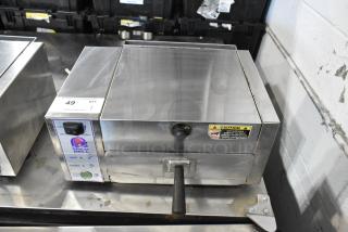 AJ Antunes CM-100 stainless steel cheese melter, 208V, 1 phase. Features control panel, Taco Bell label, and caution sticker.