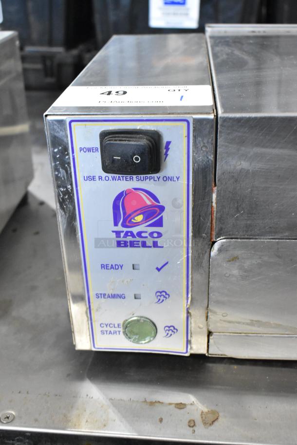 AJ Antunes CM-100 stainless steel cheese melter, commercial countertop model. Features Taco Bell branding, 208V, 1 phase.