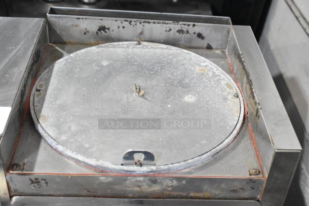 AJ Antunes CM-100 stainless steel commercial cheese melter. Used condition, 208 volts, 1 phase, visible wear on melter surface.