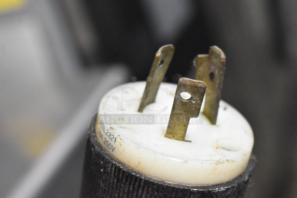 Close-up of a connector plug for a commercial appliance showing wear. Marked "HBL2321, 20A 250V."