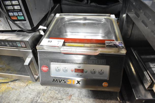 MiniPack MVS31X stainless steel commercial countertop vacuum sealer, visible control panel, used condition, safety and cleaning labels.