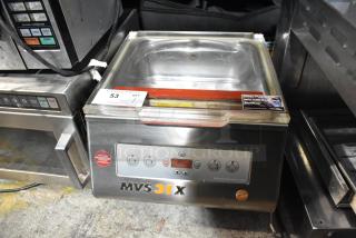 MiniPack MVS31X stainless steel commercial countertop vacuum sealer, visible control panel, used condition, safety and cleaning labels.
