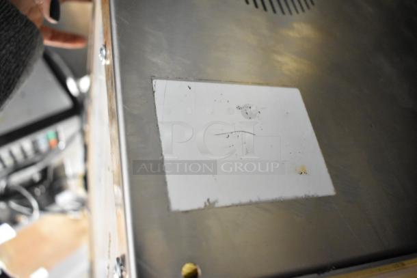 MiniPack MVS31X vacuum sealer, stainless steel, commercial countertop model. Slight surface wear visible, no labeling.