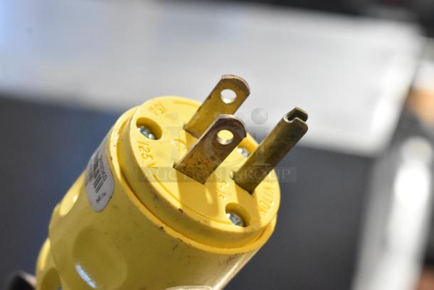 Close-up of a yellow electrical plug, labeled 125V. Part of a Roundup AJ Antunes DFW-150CF food warmer, 120V, 1 phase.