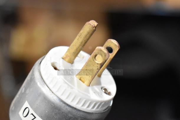 Close-up of a three-prong plug for a Nemco 6600 Stainless Steel Commercial Countertop Food Warmer, 120 Volts, 1 Phase.