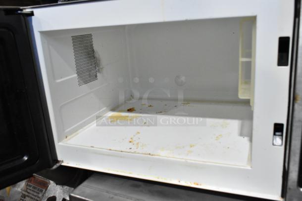 Panasonic NE-1054F stainless steel commercial microwave. Interior shows visible stains and wear. 120V, 1 Phase.