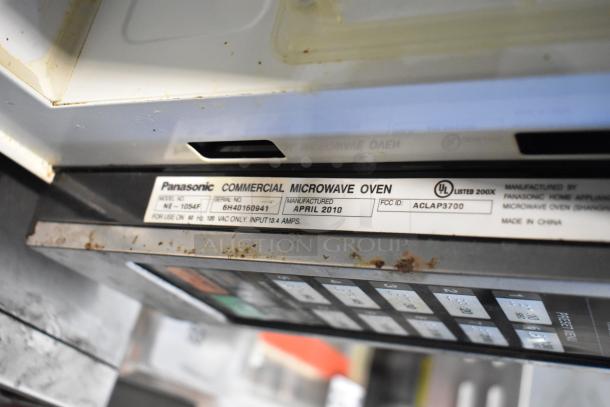 Panasonic NE-1054F stainless steel commercial microwave, model NE-1054F, 120V, April 2010, visible wear, markings shown.