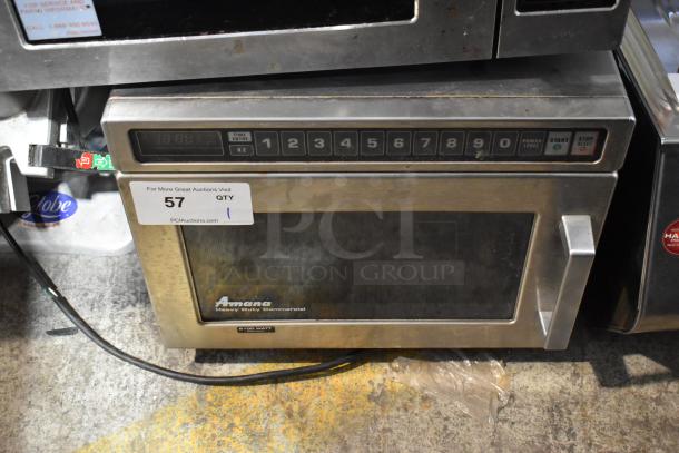 Amana HDC21 stainless steel commercial microwave, 2100 watts, keypad controls, in used condition with auction tag.
