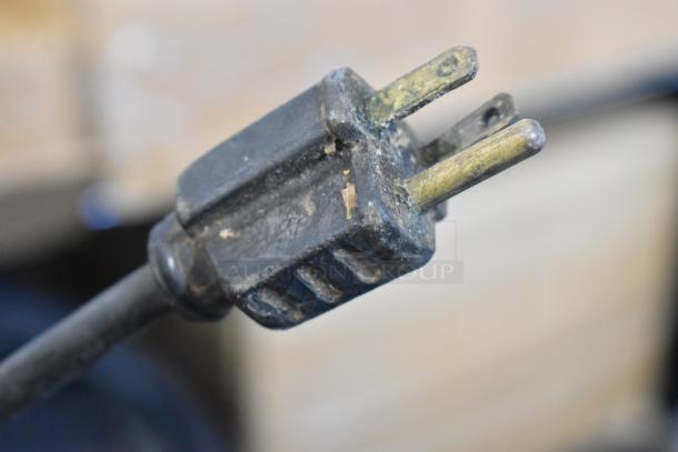 Damaged power plug of Globe GFP500 Food Processor, showing worn-out, corroded prongs.