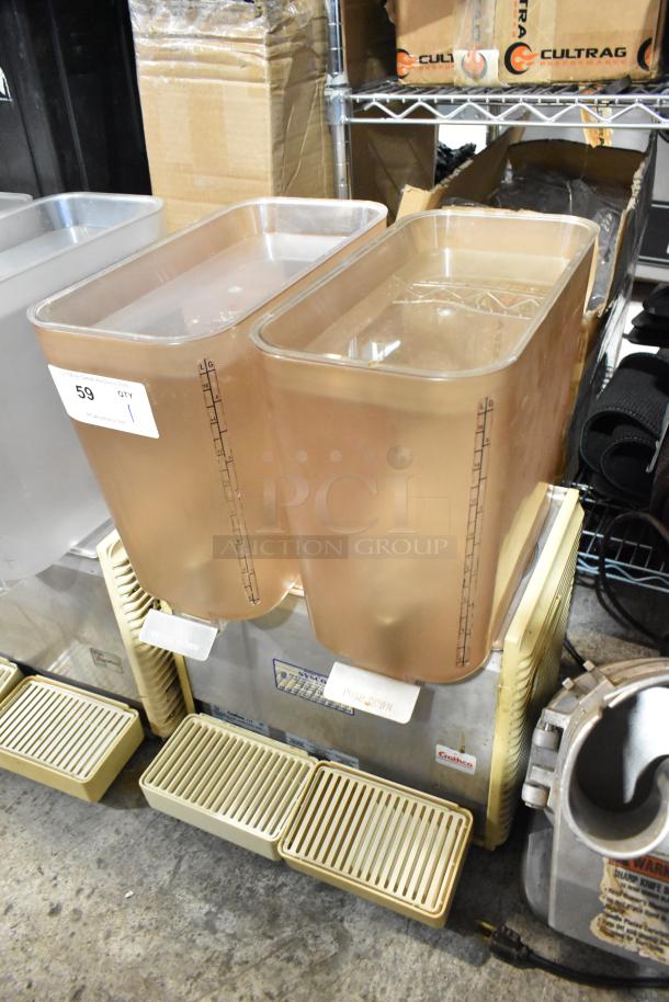 Crathco D25-4 metal commercial countertop beverage machine with 2 hoppers. Features 115V, 1 phase. Includes drip trays.