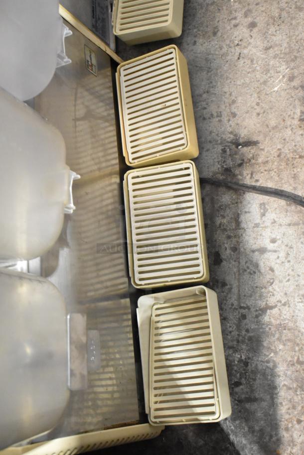 Crathco D35-4 refrigerated beverage machine with 3 hoppers, metal body. Visible wear. 115 volts, 1 phase.