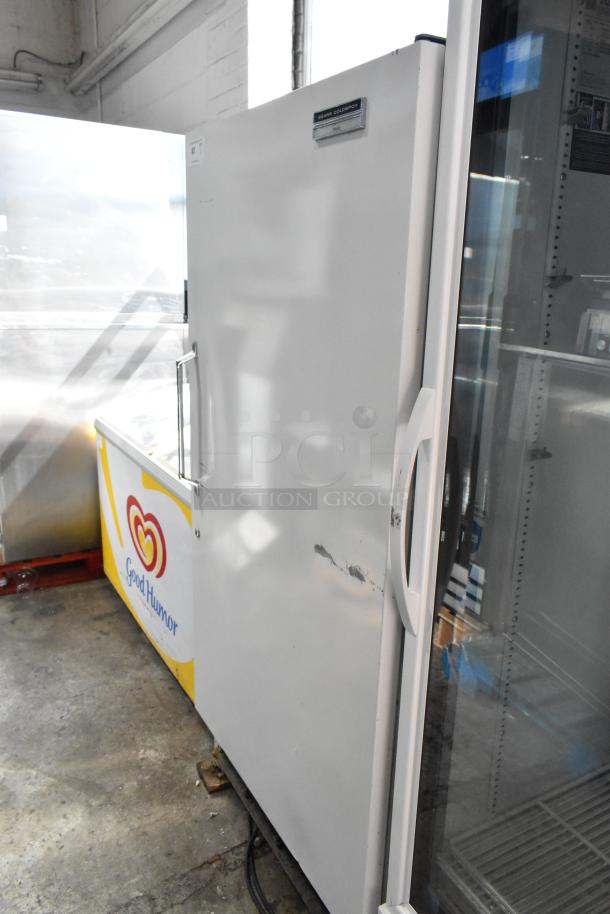 Sears Coldspot metal reach-in freezer, single door, 115 volts, visible sticker, some exterior wear.