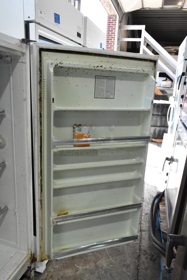 Sears Coldspot metal single door reach-in freezer, 115 volts, 1 phase. Shows signs of wear, rust visible on the door edge.