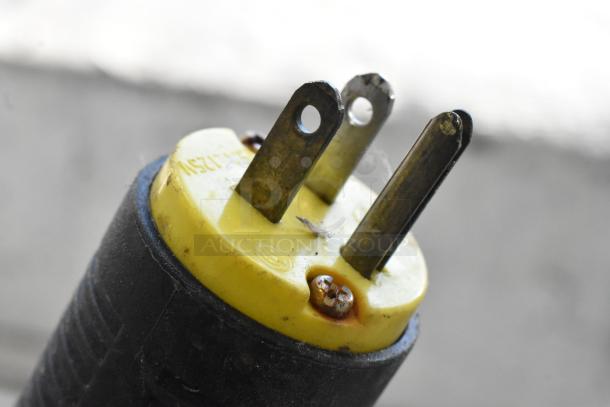 Close-up of a three-prong plug attached to a Caravell 406-995 Metal Chest Freezer Merchandiser, 115V, 1 Phase.