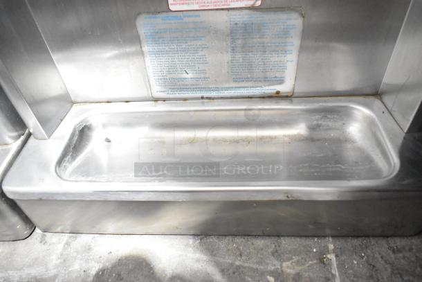 Taylor 340-27 stainless steel single flavor frozen beverage machine in used condition. Label shows operation instructions.